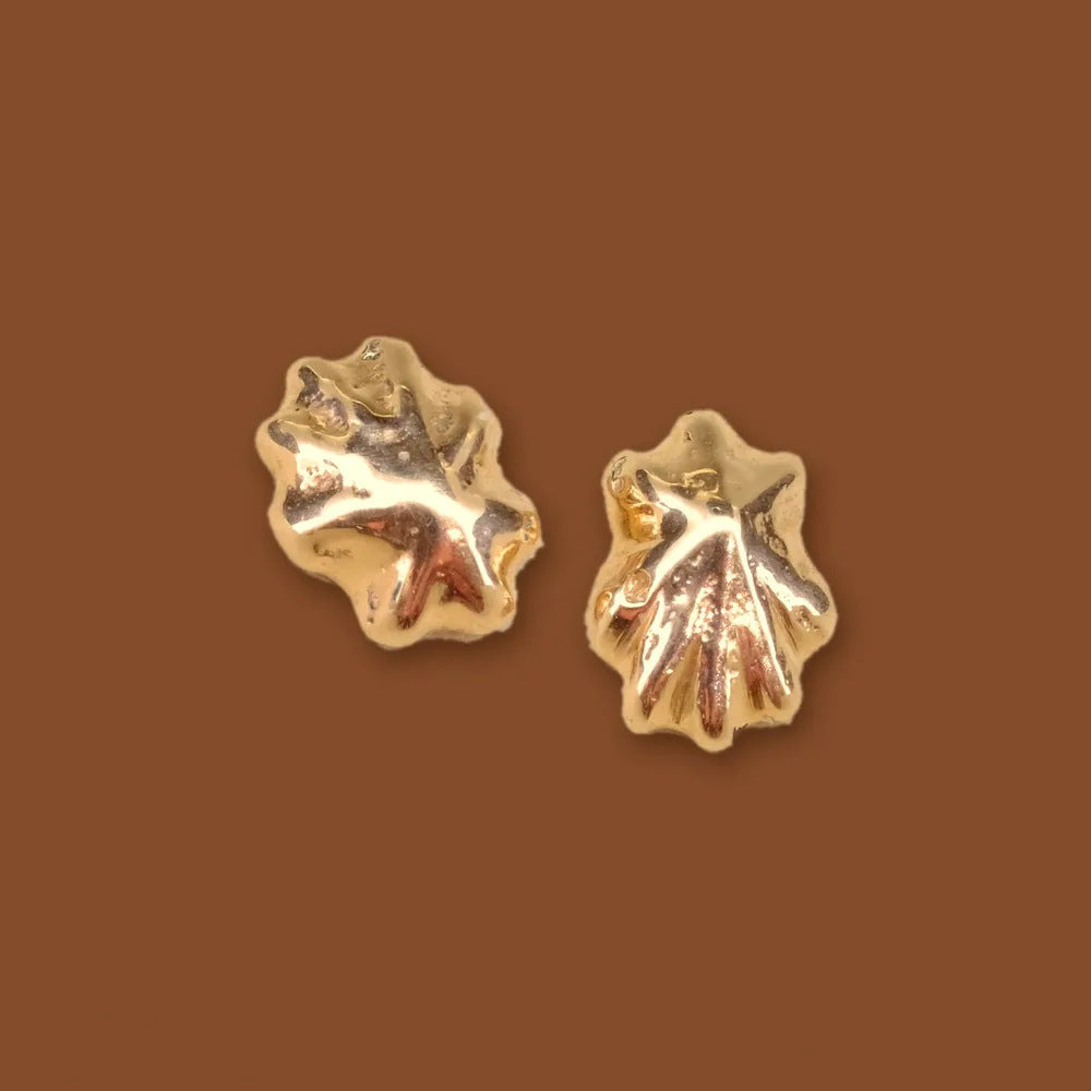 Limpet studs, a mismatched pair of small gold limpet shell earrings