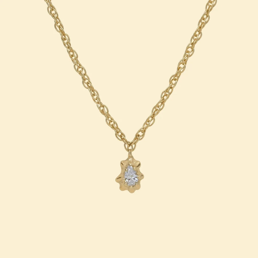 Pear diamond pendant, a pear-cut diamond set in a gold limpet shell