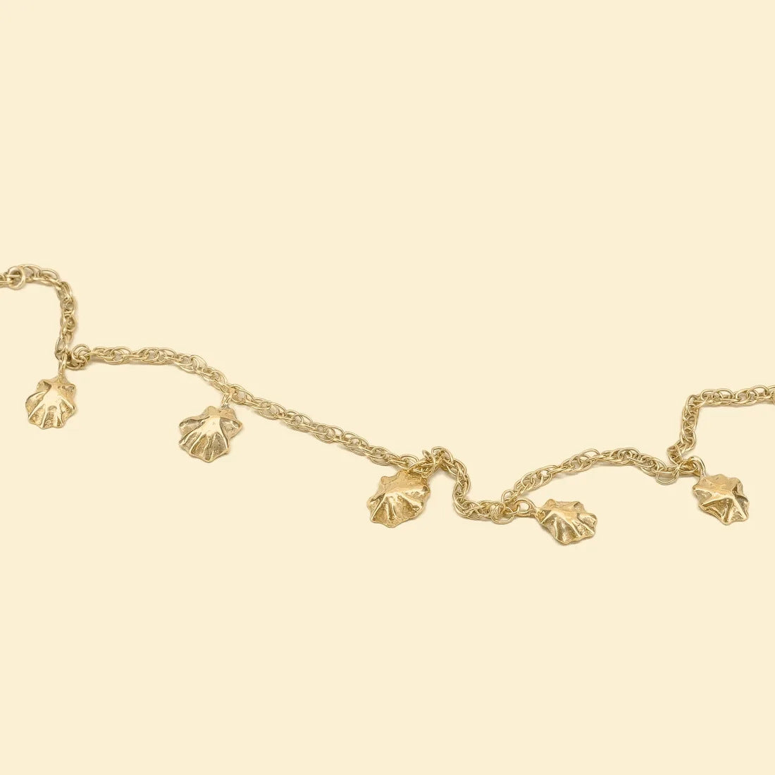 Shell bracelet, a gold chain with small cast limpet shells