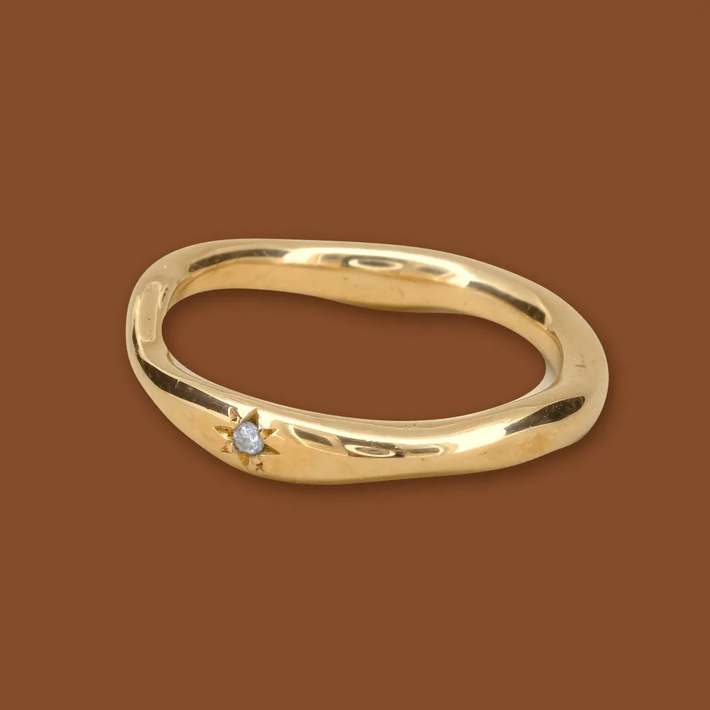 Star band, a wavy gold ring with a star-set diamond