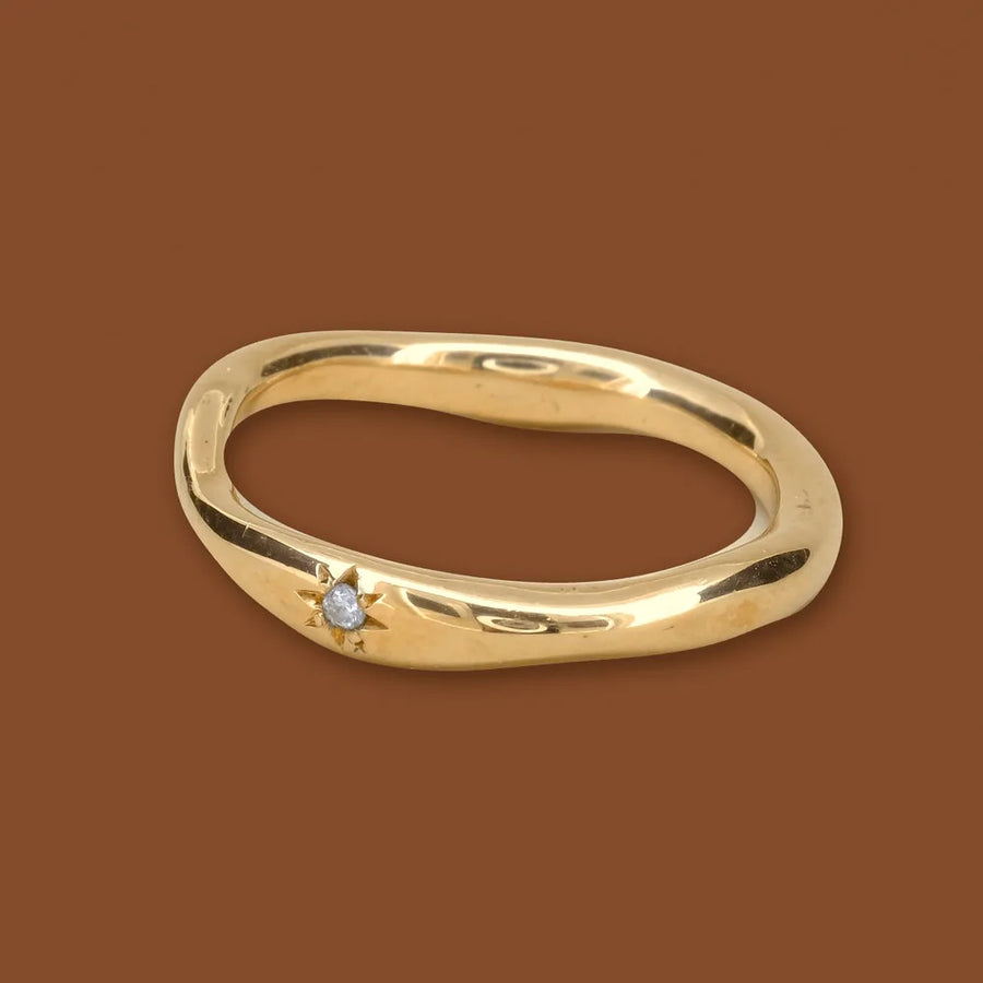 Star band, a wavy gold ring with a star-set diamond