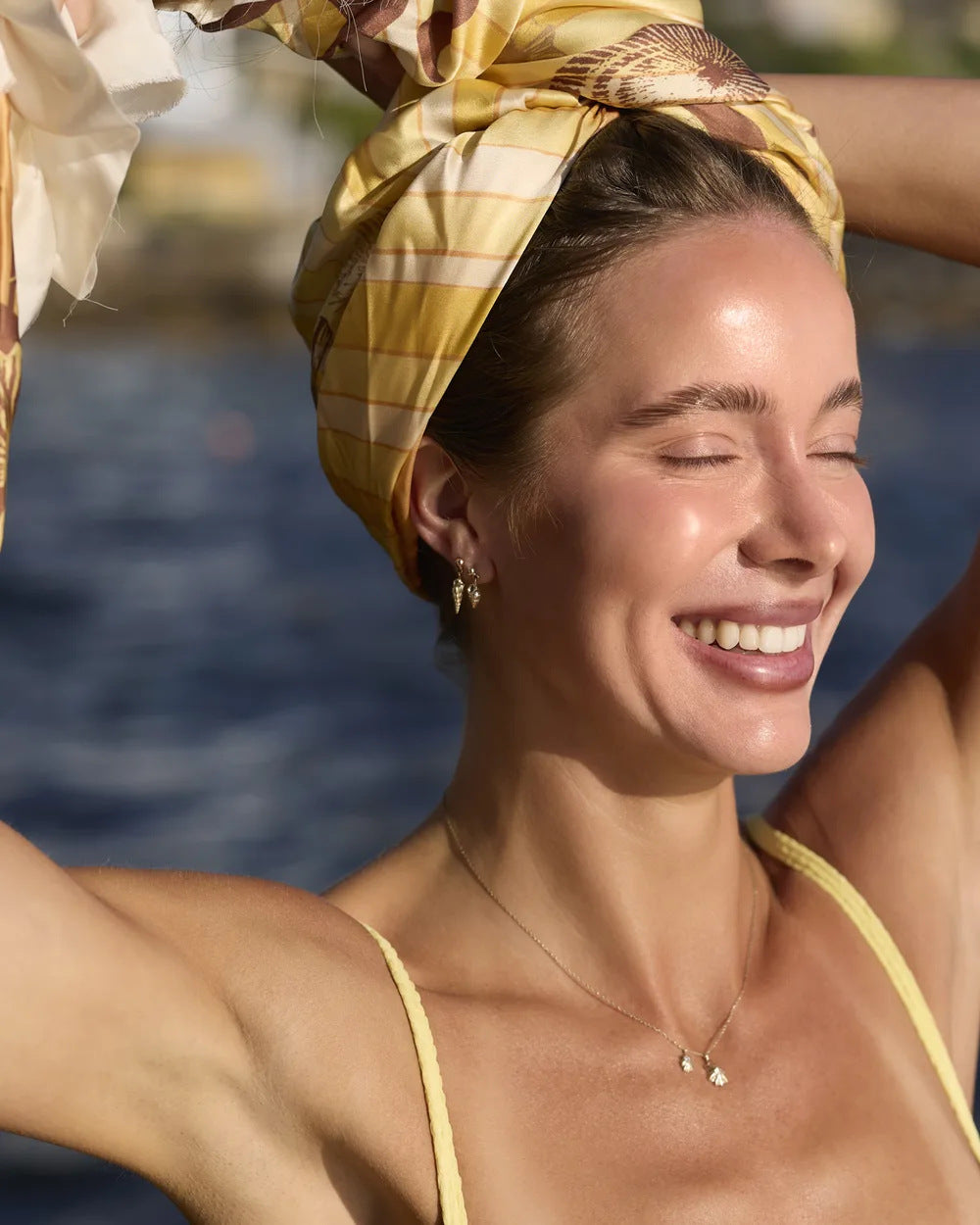 Spiral shell drop earrings worn by the harbour in the sun
